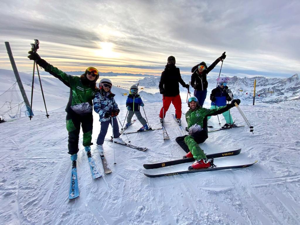 Alpine Ski School instructors and guests on a slope above Crans-Montana