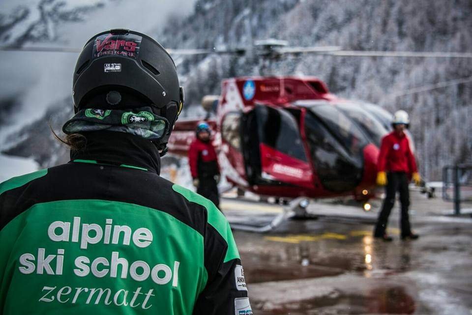 An Alpine Ski School instructor in Zermatt colours on a mountain day